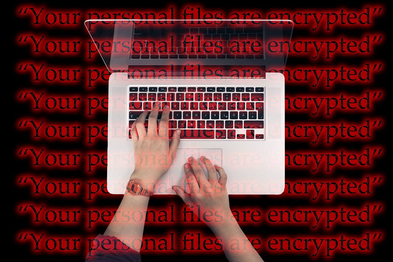 A laptop keyboard lit in blue, suggesting cyber security.